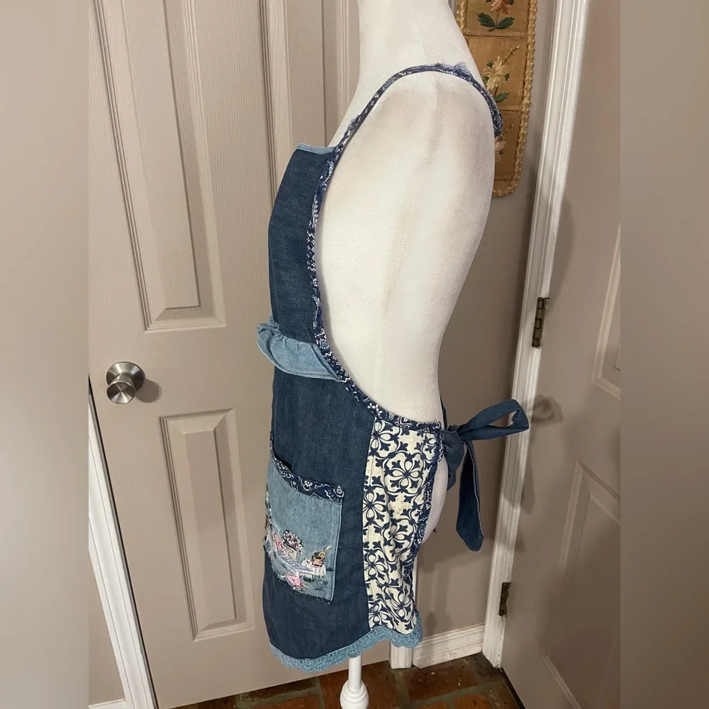 Vintage medium wash light weight ruffled denim apron with embroidered pocket.